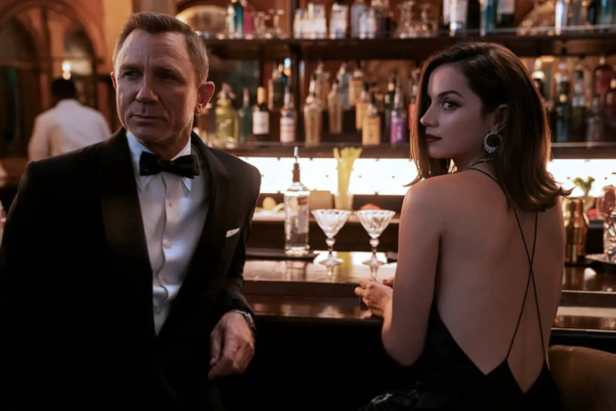 Daniel Craig as James Bond with Ana de Armas and Mermaid Bottles in the background