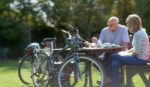 Man and woman at lunch table with bicycles