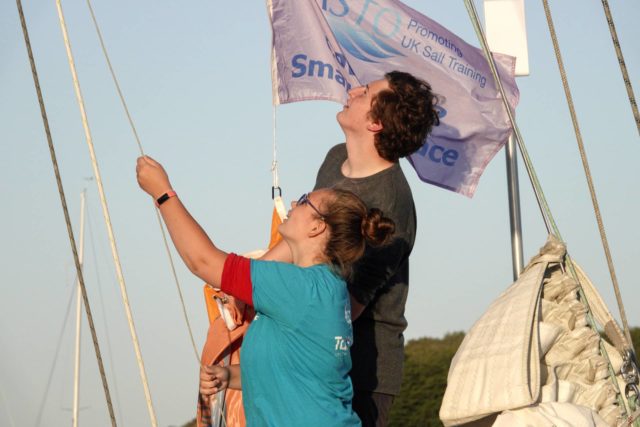 Trainees raising ASTO Small Ships Race flag - credit Max Mudie - ASTO