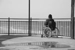 Person in a wheelchair by the sea