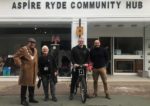 Councillors outside the Aspire community hub with the bike and staff member
