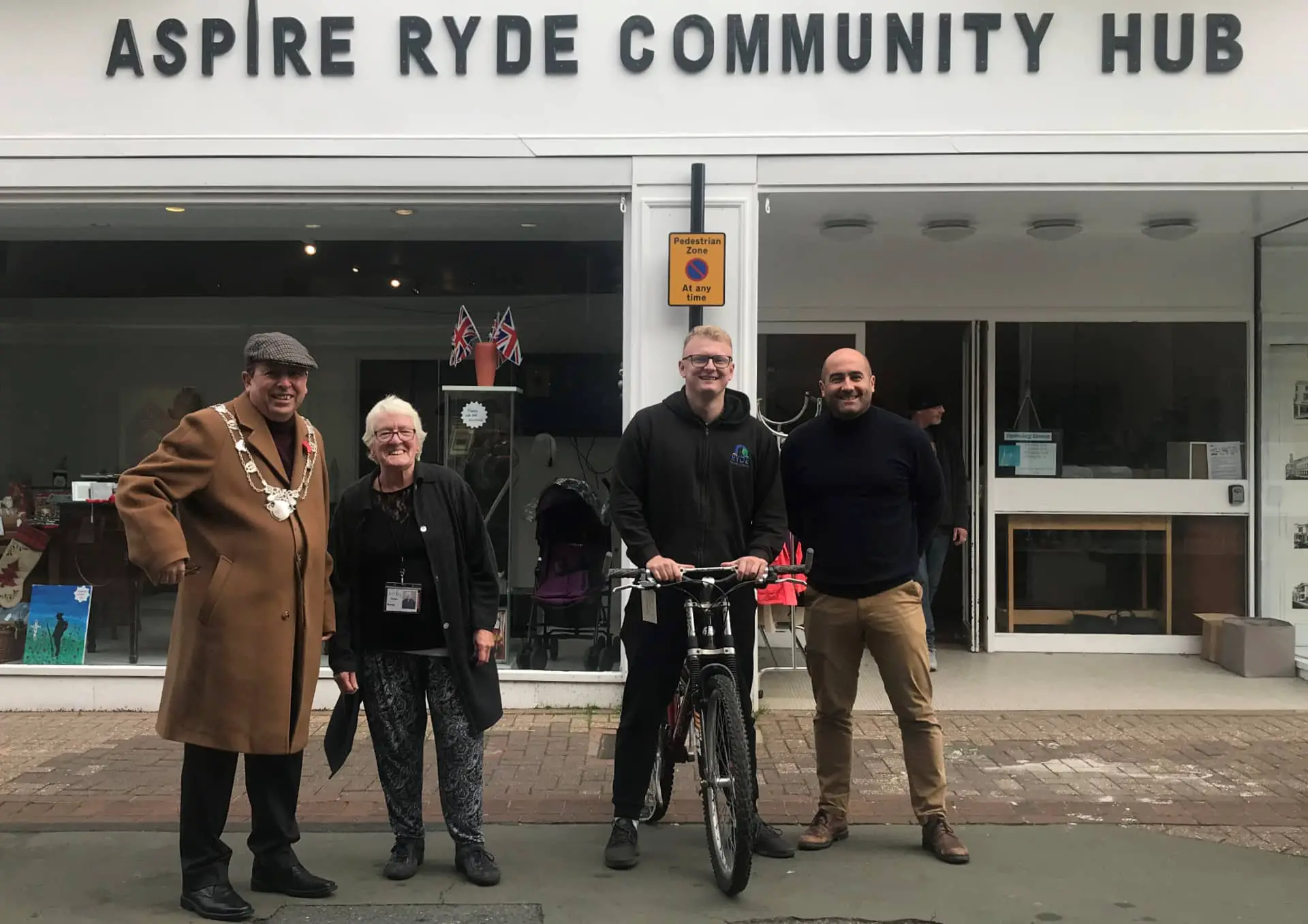 Councillors outside the Aspire community hub with the bike and staff member