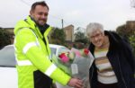 Wightlink Leading Rating Mark Mitchell gives flowers to customer Hilary Spinks who is now back home in Ryde after her holiday in Yorkshire