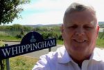 Michael Paler standing by Whippingham sign
