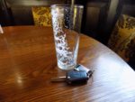 empty beer glass on table in pub with car keys