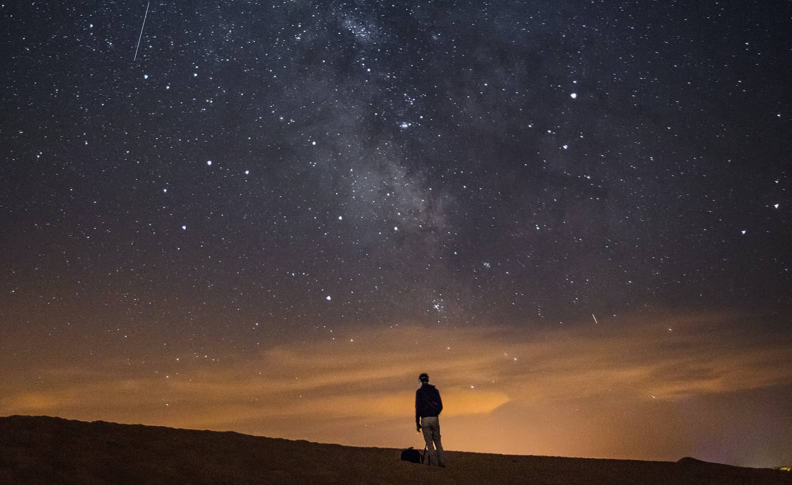 Silhouette of person looking at stars