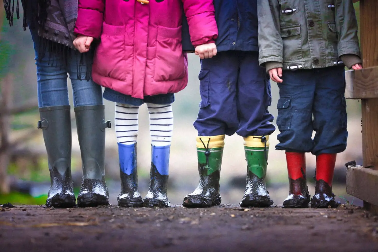 photo of childrens legs - in jeans and muddy wellies by Ben Wicks