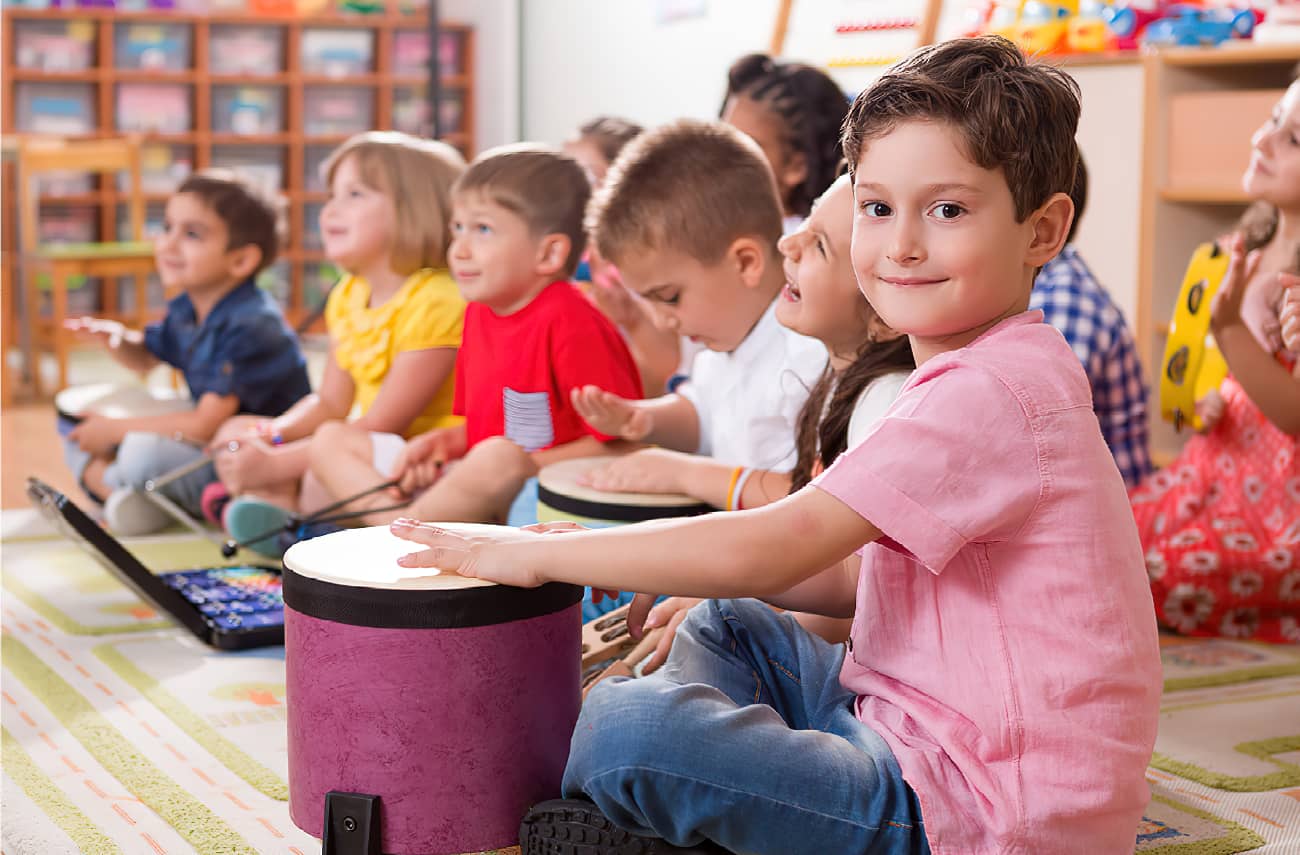 Young children in a group drumming