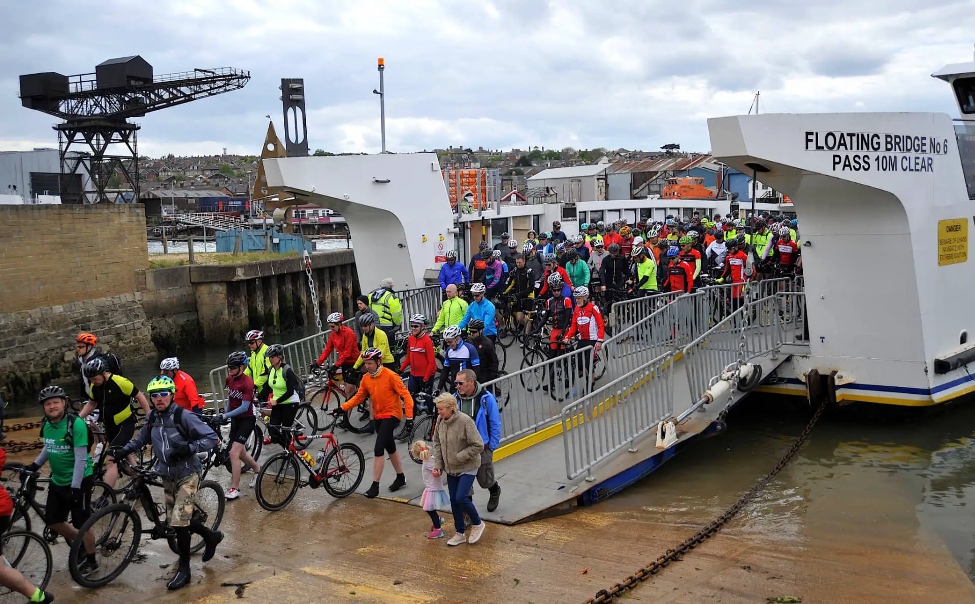 Cyclists alighting from floating bridge -