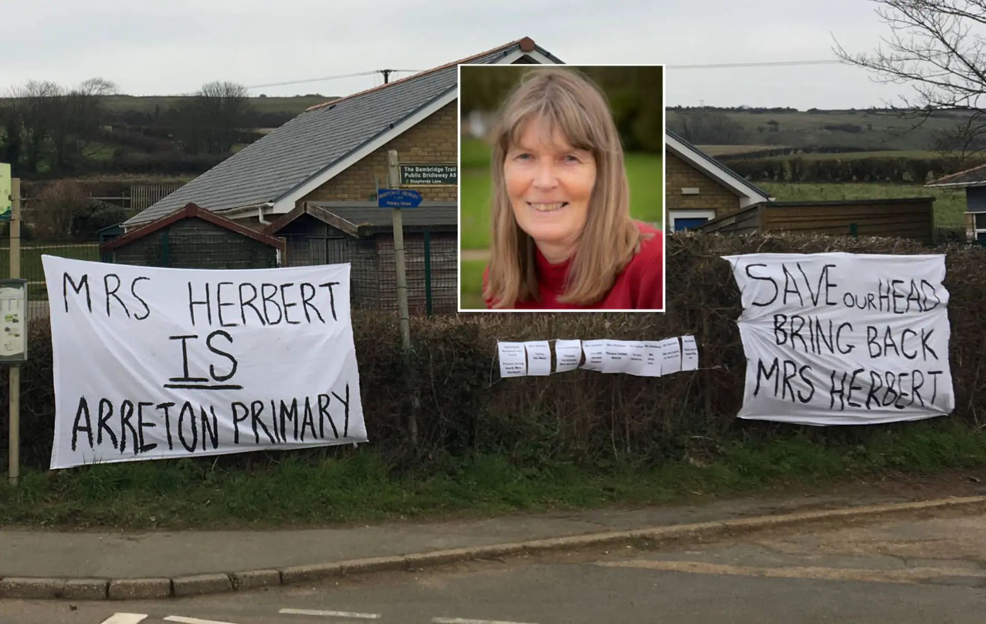 Banners outside Arreton primary school with photo inset of Maria Herbert