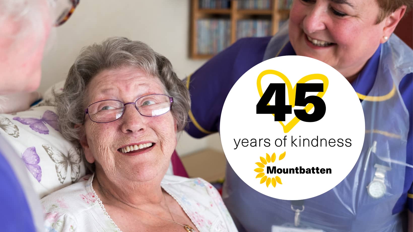 Smiling patient with two Mountbatten nurses and new 45 years logo
