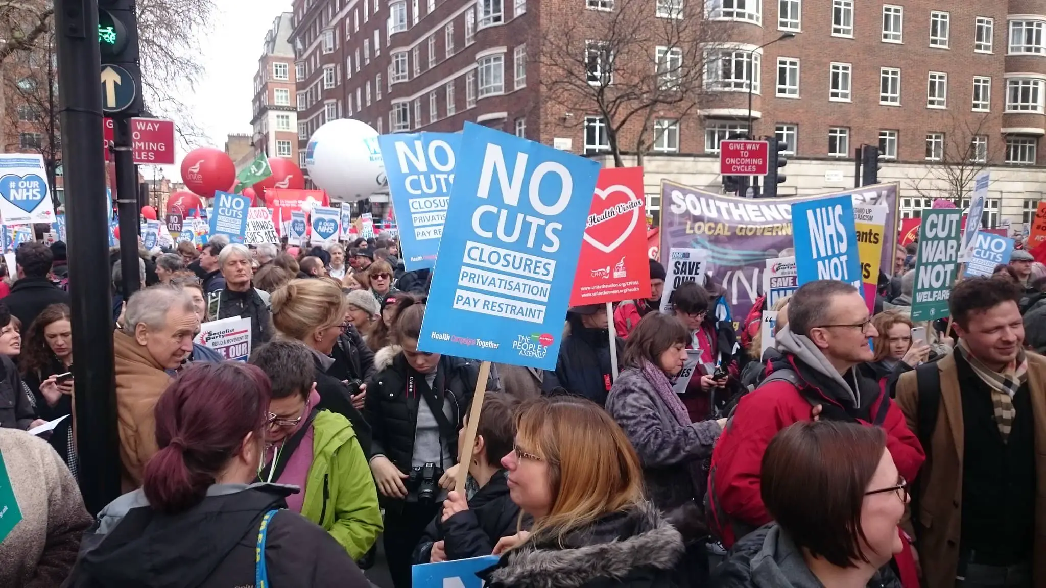 People with placards on a Save the NHS march