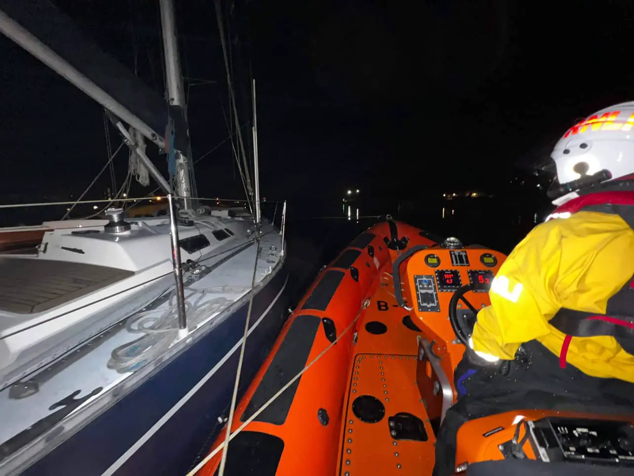 yacht being towed to safety by Cowes RNLI