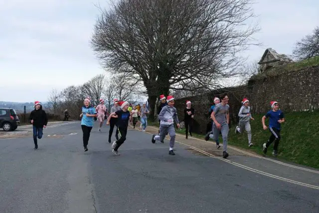 Students taking part in the Santas Dash up to Carisbrooke Castle