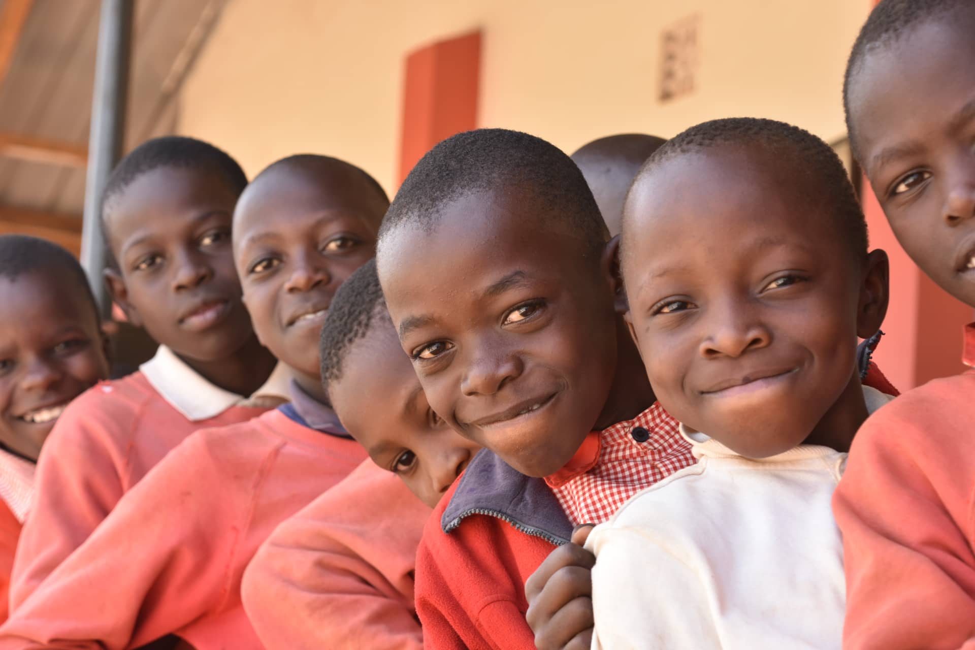 A row of Uzima children smiling to the camera