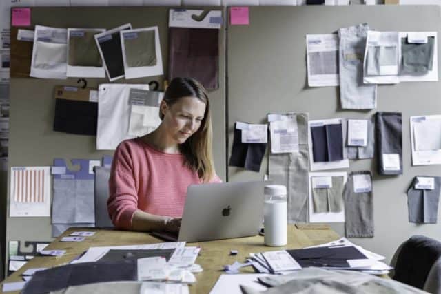 Woman working on laptop in her studio 