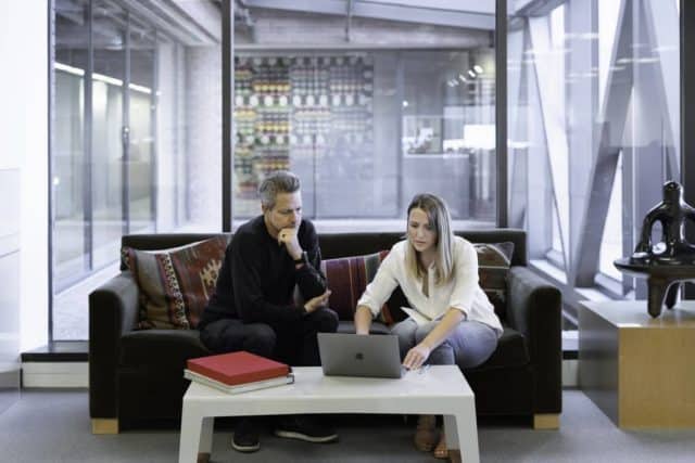 woman and man looking at computer 