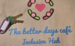Better Days Cafe Inclusion Hub tote bag and keys