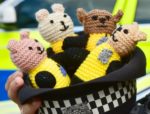 Knitted Bobby buddies in an officer's hat