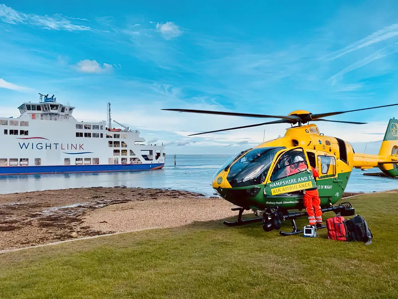 Wightlink ferry in background with Air Ambulance in foreground