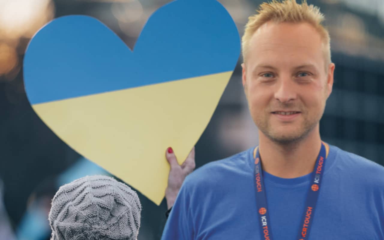 Woman holding Ukrainian loveheart at rally with Colin Ringer
