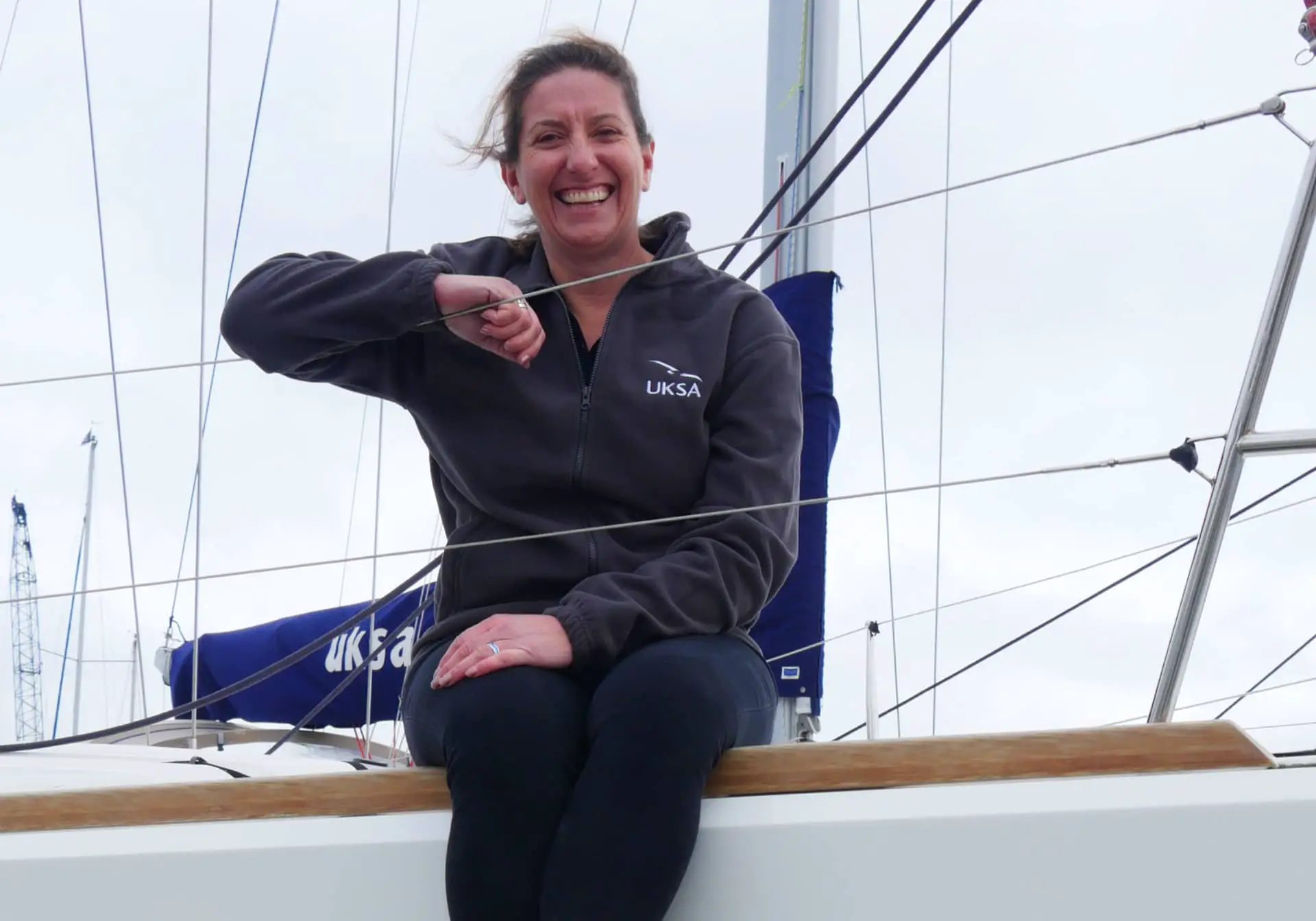 Dee Caffari on UKSA boat, smiling to the camera
