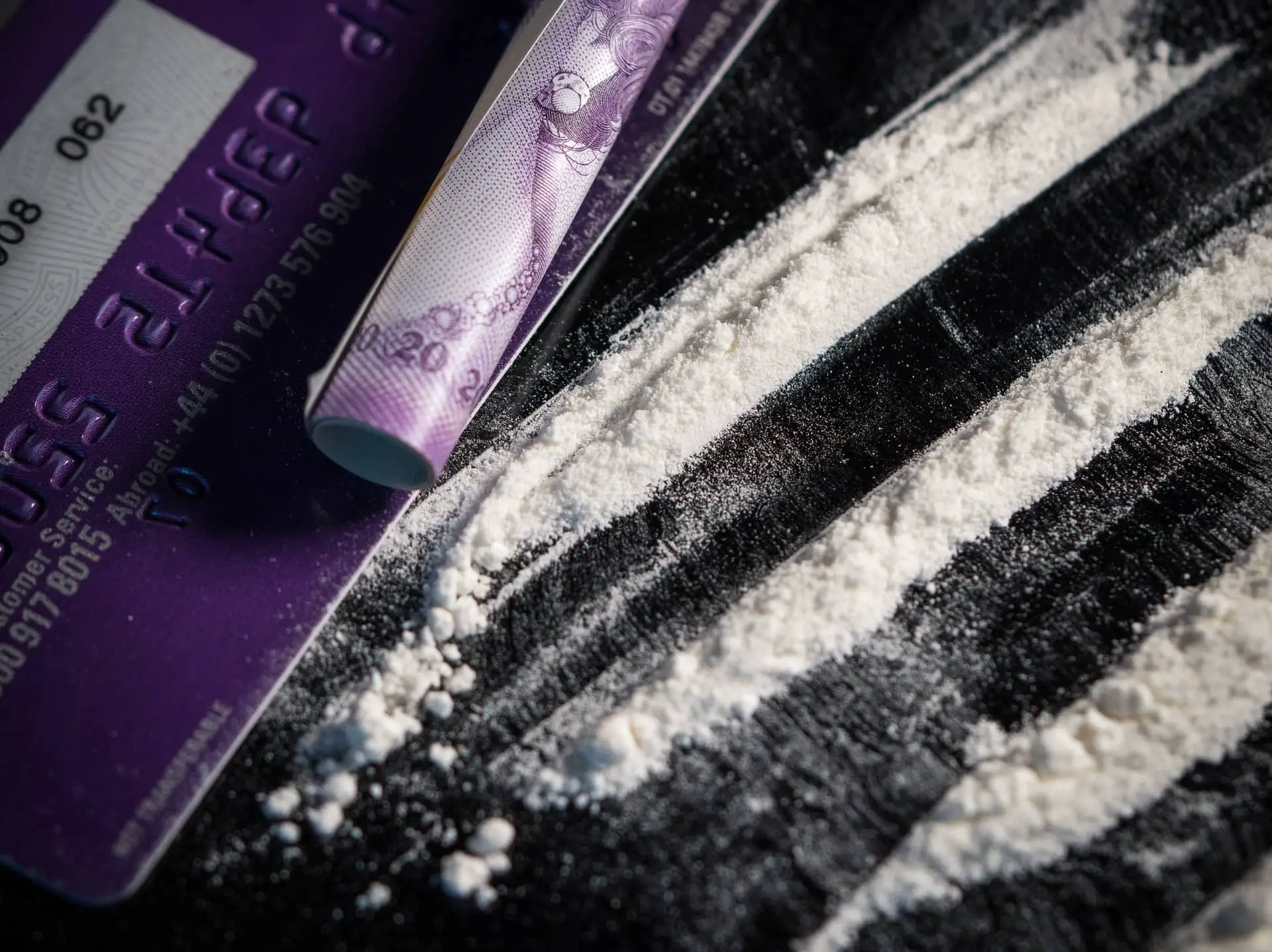Lines of cocaine, a rolled up bank note and credit card