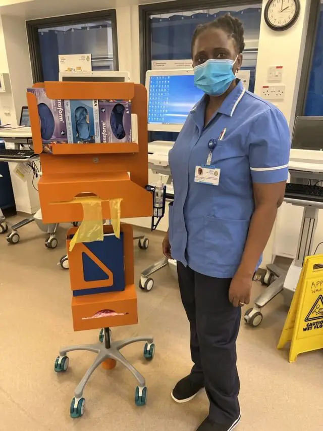 Nurse on Appley Ward standing next to one of the new PPE stations