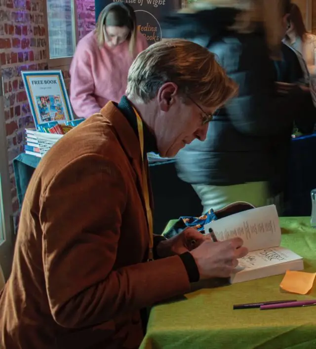 Philip Reeve signing books  © Ffion Wood
