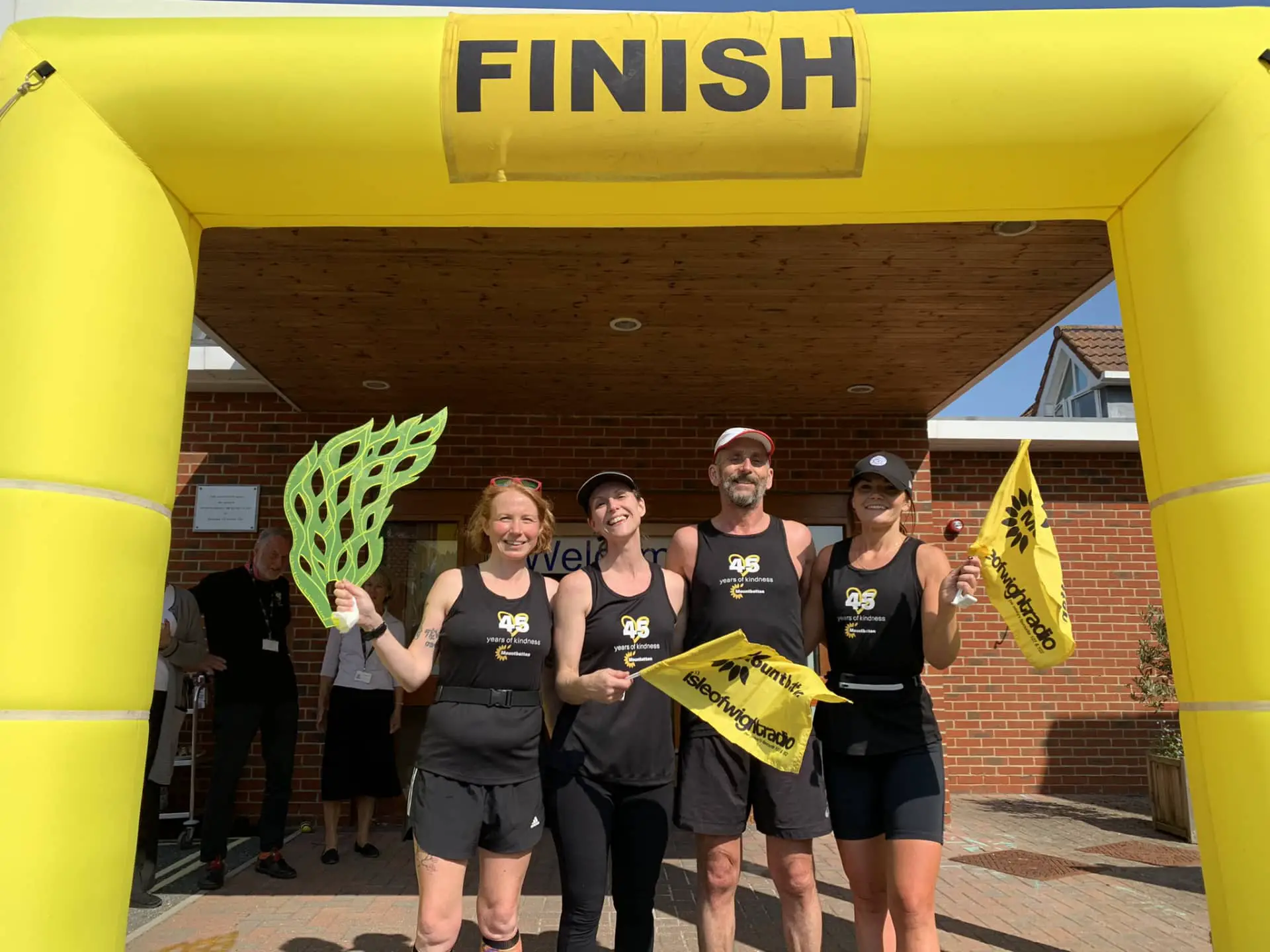 Torch runners at finish line with Lisa Traxler's ‘flame of kindness’,