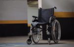 An abandoned wheelchair in car park