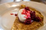thin pancake with ice cream and raspberry