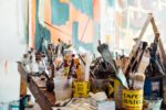 Artist studio with canvas in background and paint brushes in foreground