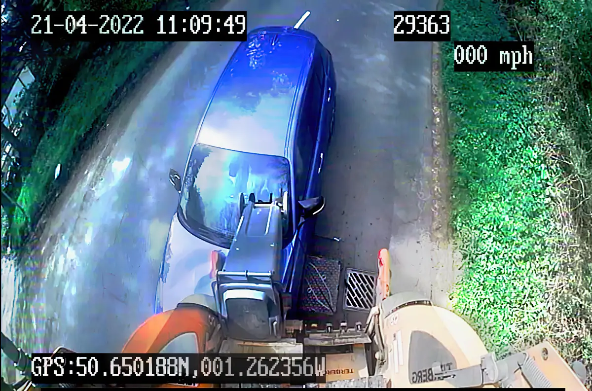 Car driving into back of waste truck