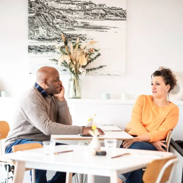 Ainsley Harriott and Grace Dent sitting down in Smoking Lobster by Gianpaolo Mario