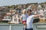 Father and child on deck of a Red Funnel ferry as it leaves Cowes