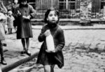Photo of girl holding milk bottle from the 1950s