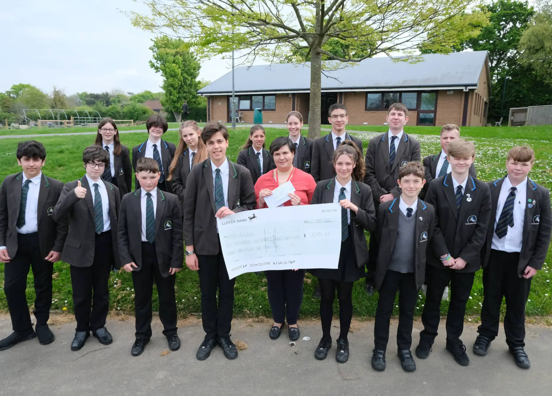 Students with Victoria and a giant cheque