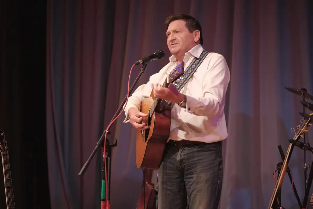 Chris Milner playing guitar on stage