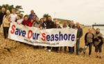 Save our Seashore campaigners on the beach with a banner