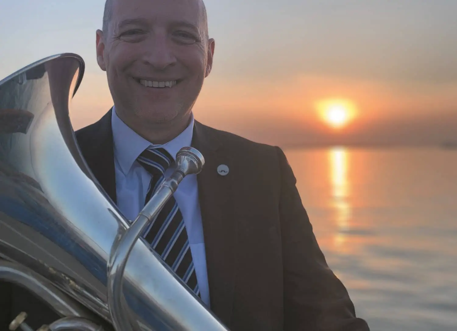 Will Doyle with euphonium in front of sunset