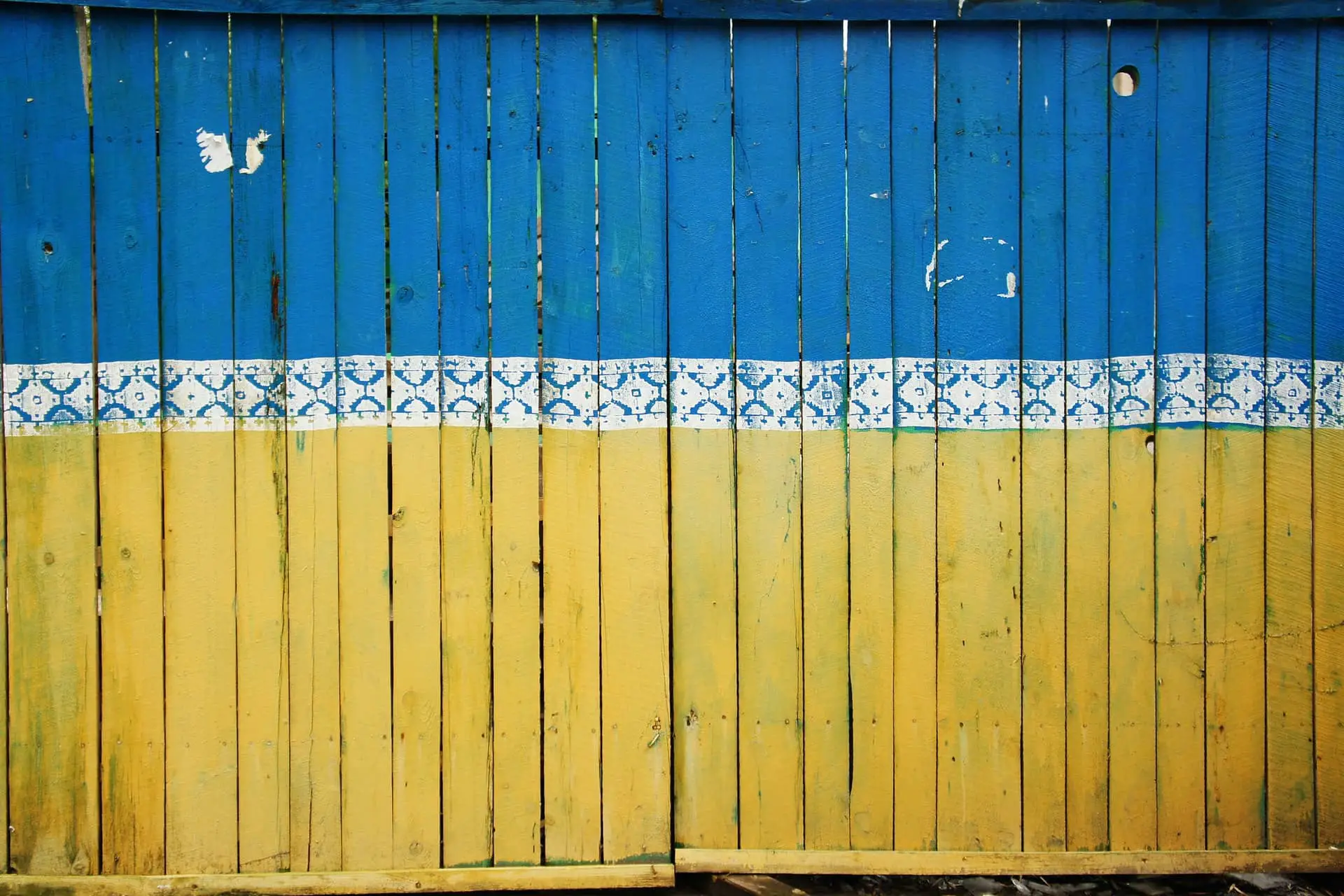 Fence painted in colours of Ukraine