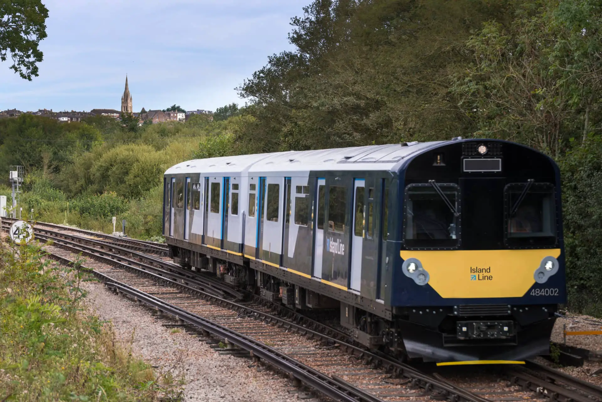 Island Line Class 484 on tracks with All Saints Church Ryde spire in background