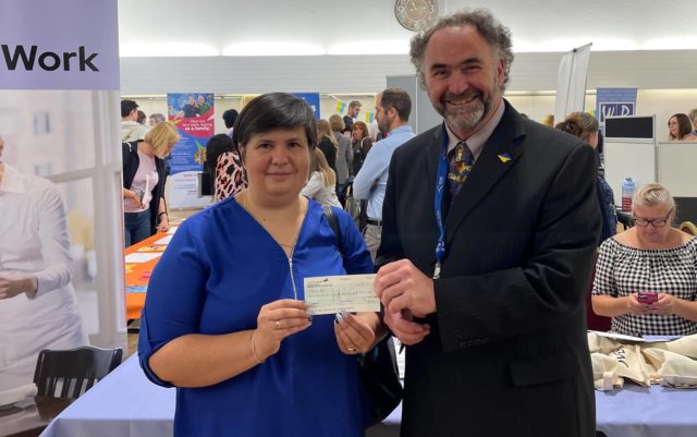 Job Fair for Ukrainian guests - Chris Jarman presenting cheque to Victoria Dunford from MAD-Aid