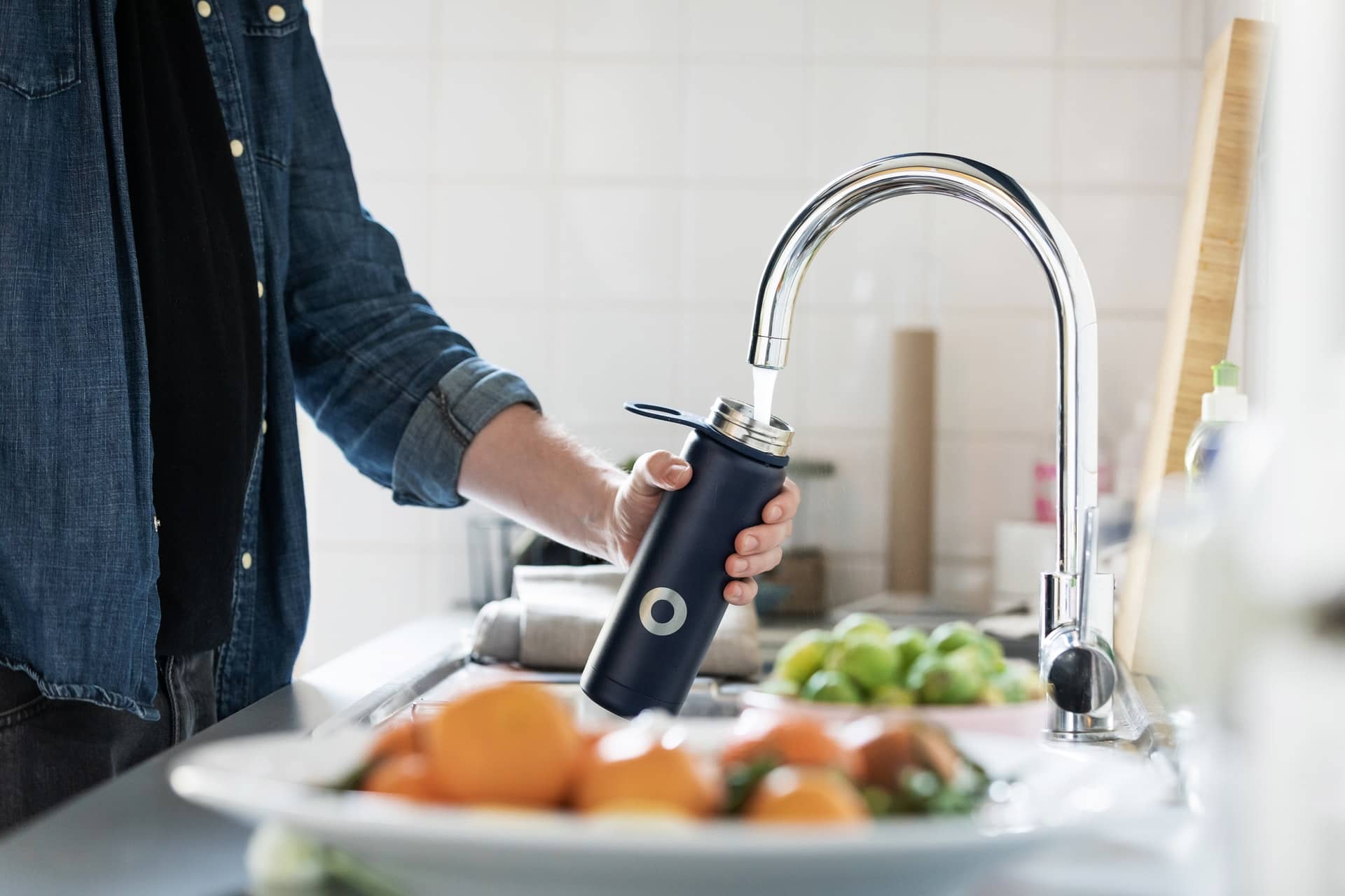 Man filling water bottle