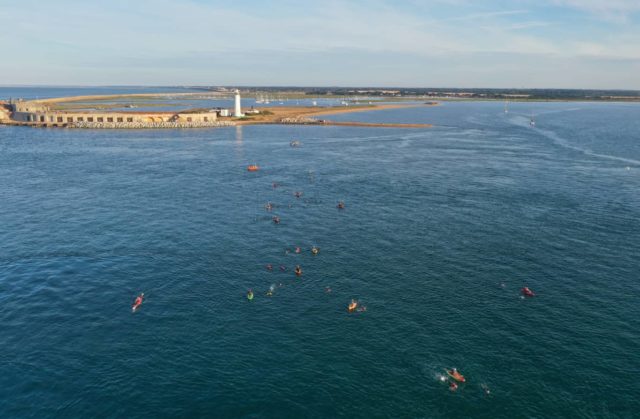 Drone Photography: © Lee Argle of swimmers and kayakers Leaving Hurst