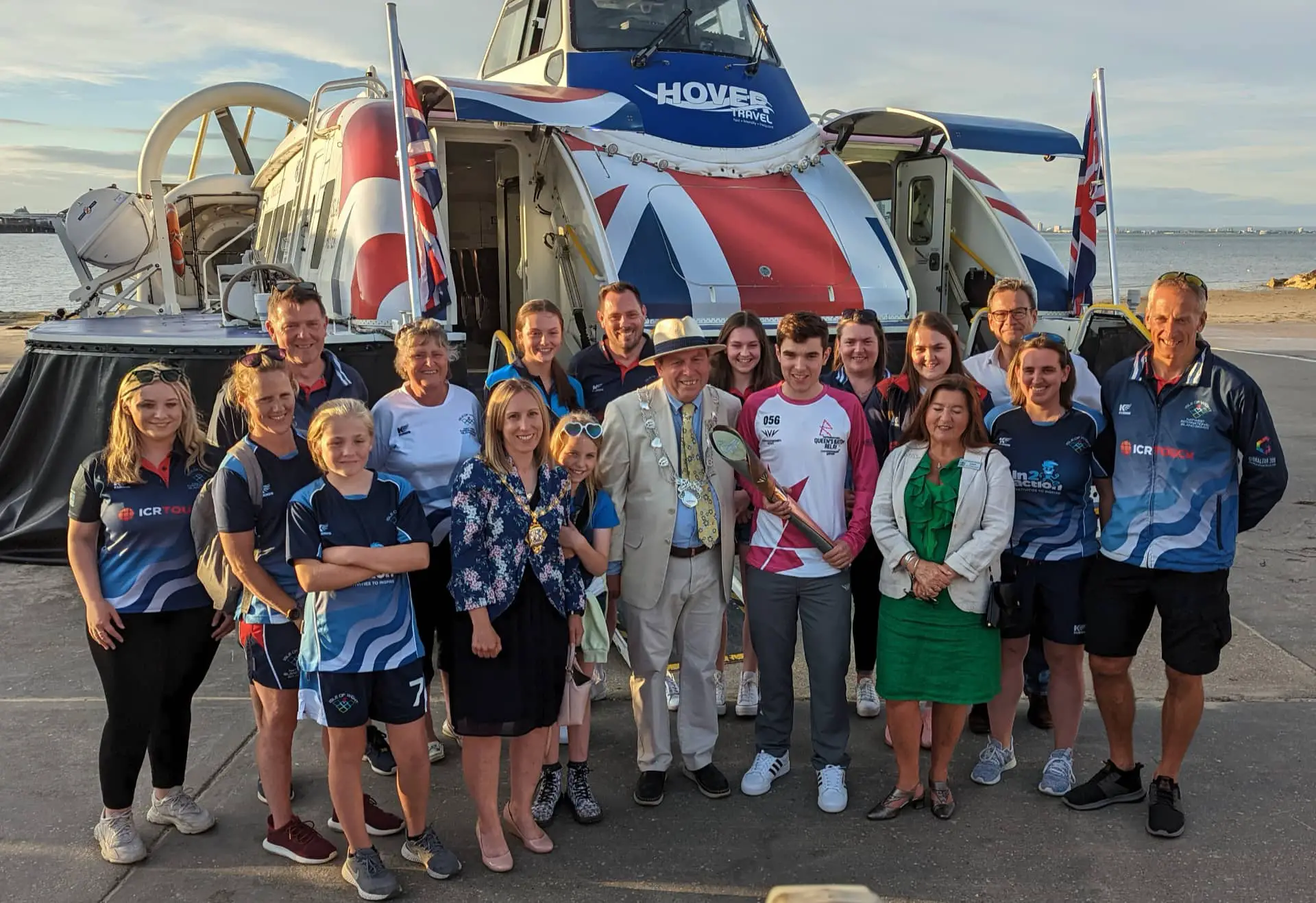 Local civic leaders and Island Games athletes greet Nicholas Earley, Queen's Baton Bearer, as he arrives by hovercraft on the Isle of Wight