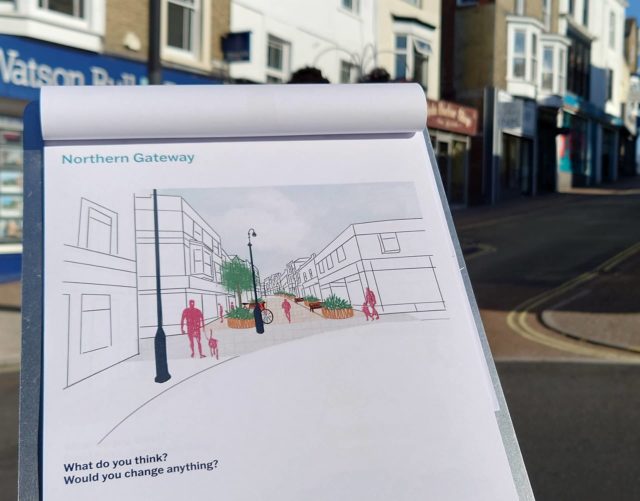 Clipboard with concept drawings and Ryde High Street in background