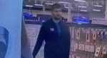 CCTV image of man walking through store