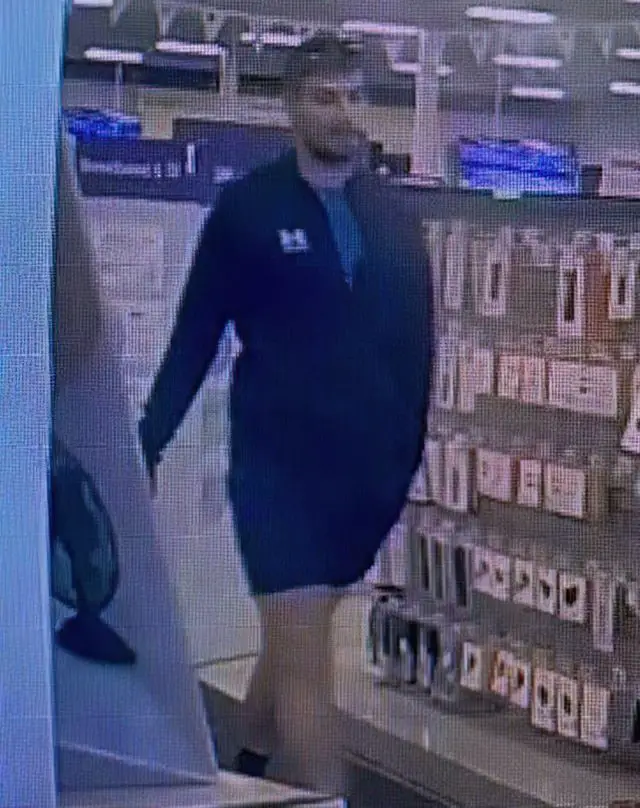 CCTV image of man walking through store